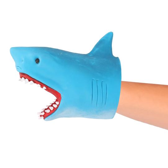 A blue shark-shaped glove or puppet with an open mouth showing white teeth and red gums, worn on a person's hand against a plain white background.