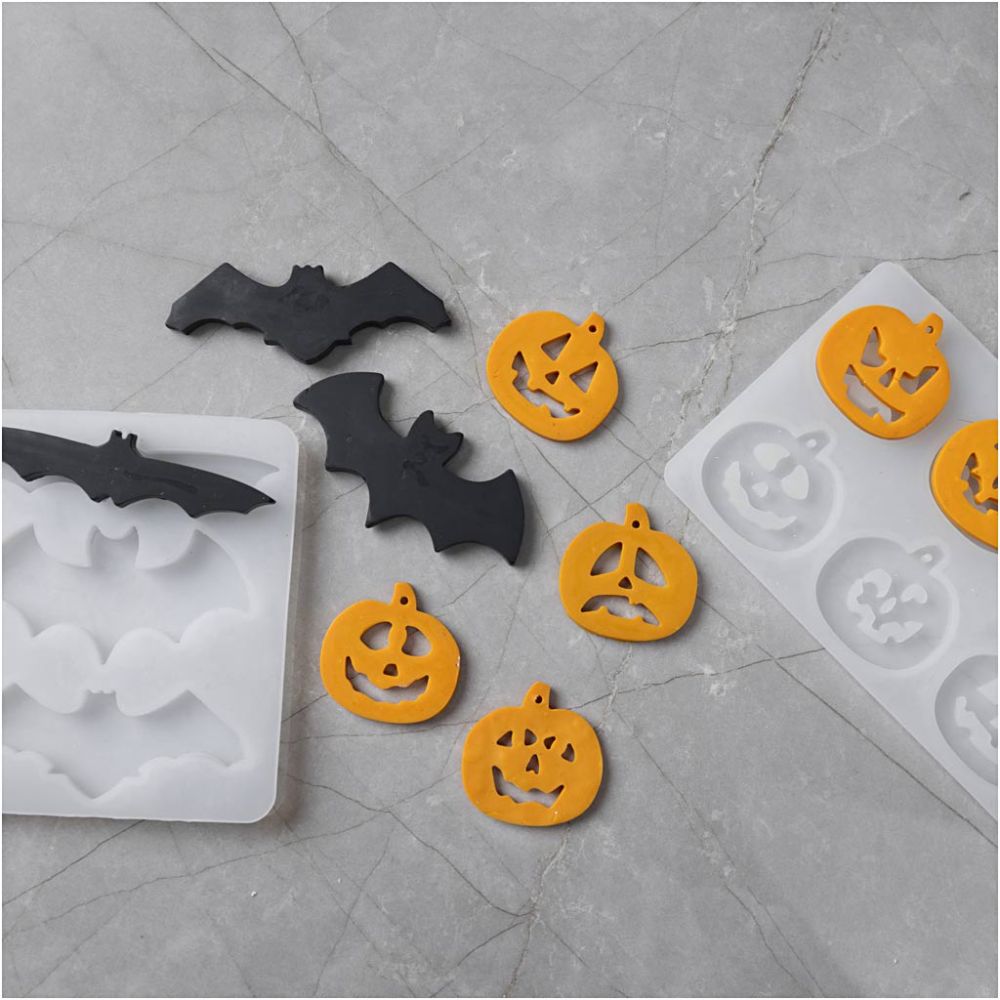 Halloween-themed silicone molds on a gray surface