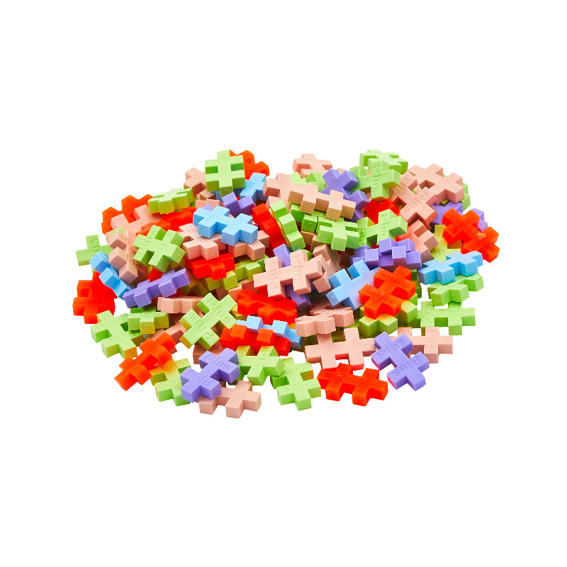 Colorful pixelated cross-shaped building blocks on a white background