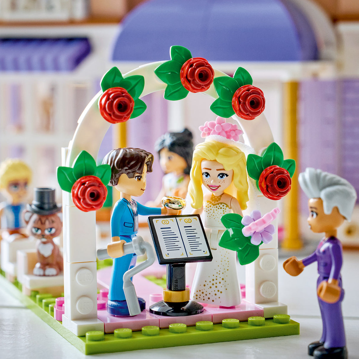 Toy wedding scene with characters under a floral arch