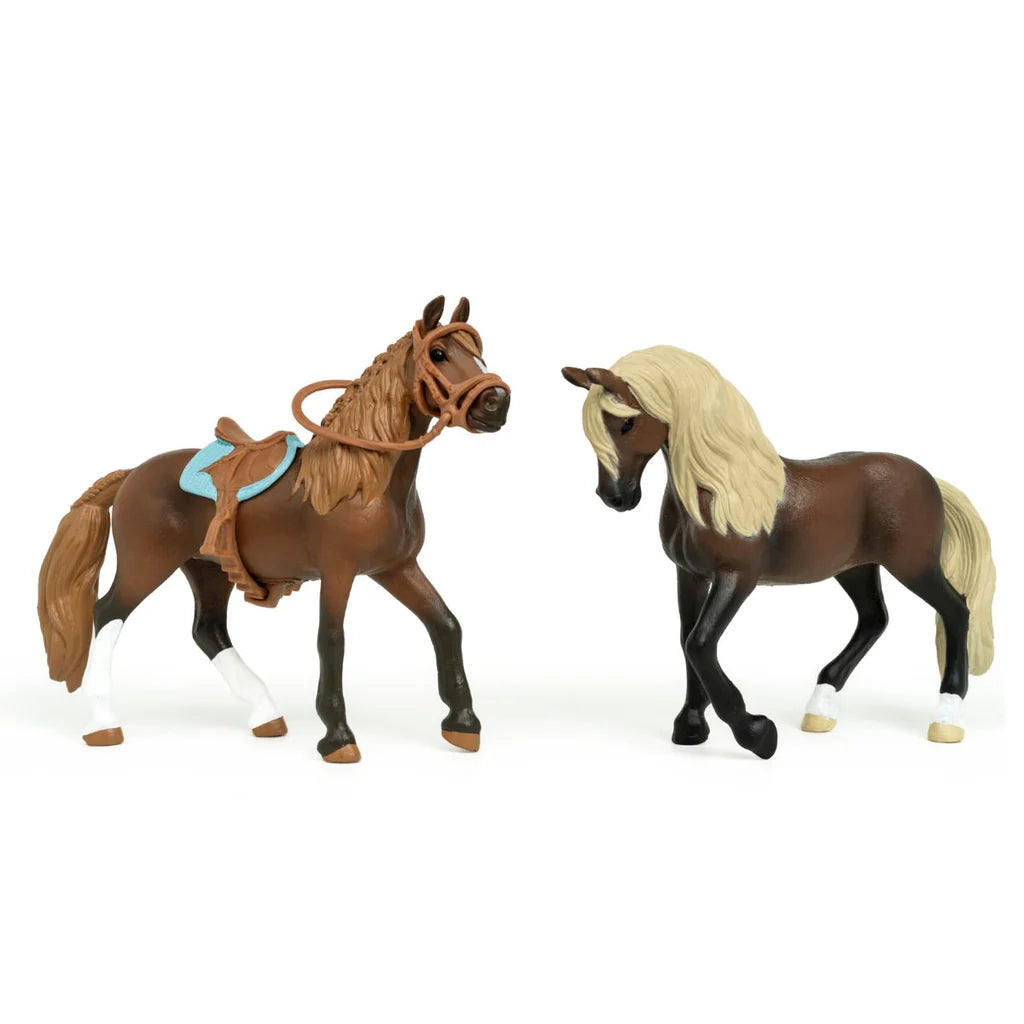 Two toy horses on a white background