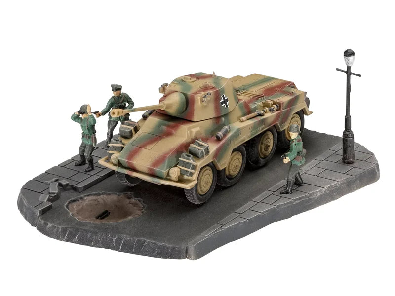 A detailed miniature model of a German WWII armored vehicle on a gray street-scene base with small figurines of soldiers and a street lamp, photographed on a white background.