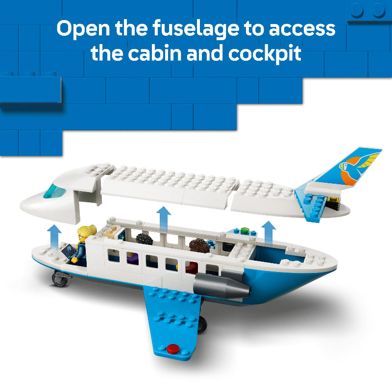 Toy airplane model with open fuselage showing cabin and cockpit, on a blue background.