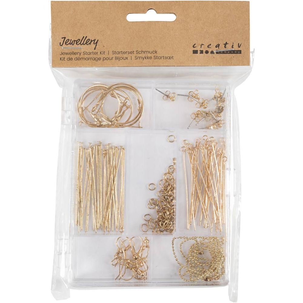Jewelry starter kit with gold jewelry components in clear packaging on a white background