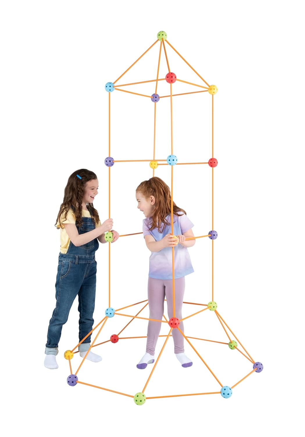 Two children playing with a large geometric structure made of colorful interlocking pieces on a white background.