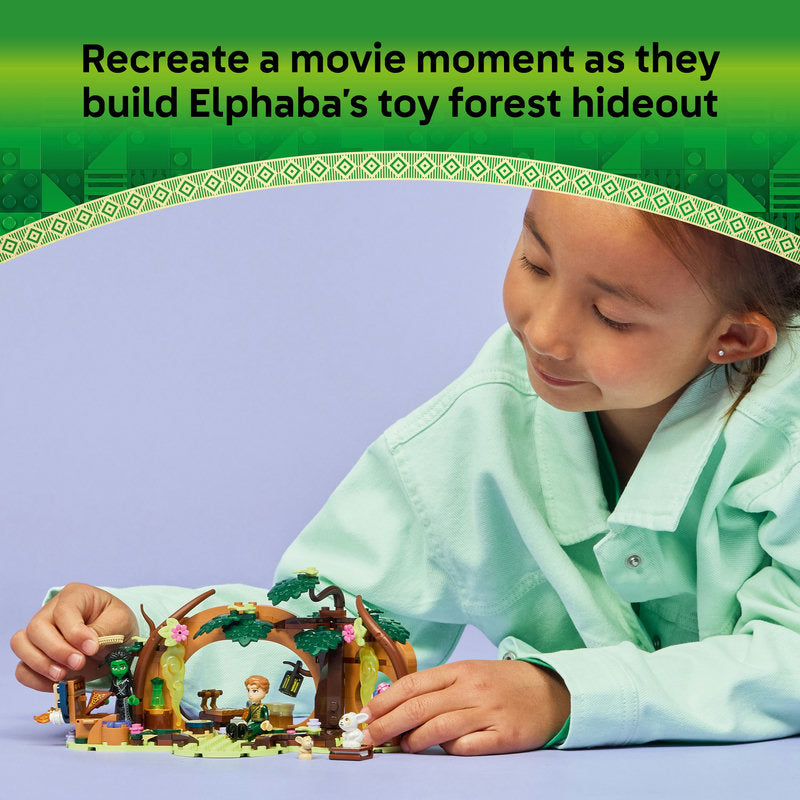 Child playing with a toy set, surrounded by green and purple colors, with text about building Elphaba's toy forest hideout.