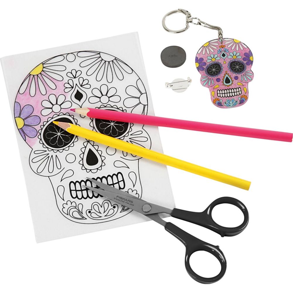 Coloring sheet with skull design, colored pencils, scissors, and a keychain with a skull design on a white background.
