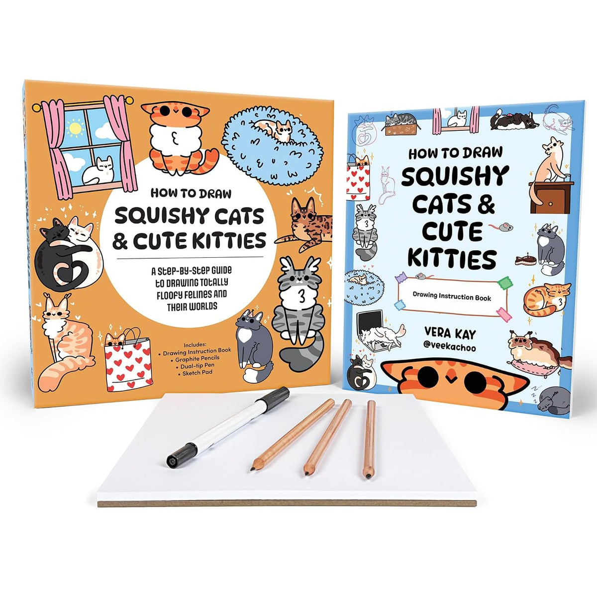 A drawing guide set for 'Squishy Cats & Cute Kitties' by Vera Kay, featuring an illustrated book with an orange cover, another book with a blue cover, a white notepad, and three drawing pencils on a white background.