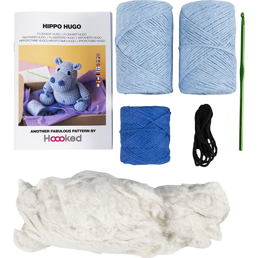Knitting kit with yarn, a crochet hook, and a pattern book on a white background