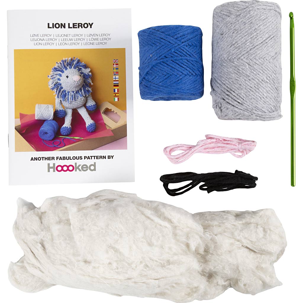 Knitting kit with yarn, needles, and Lion Leroy toy packaging.