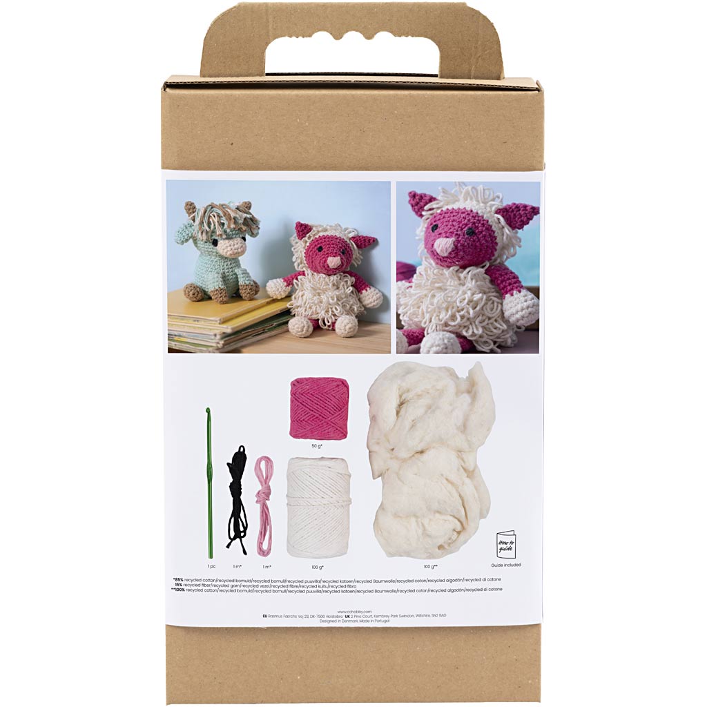 Knitting kit packaging with yarn, needles, and finished knitted toys on a white background