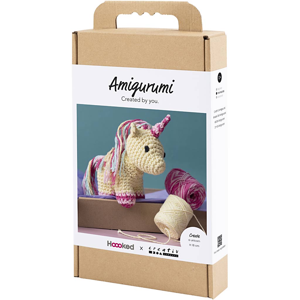 Amigurumi unicorn kit packaging with yarn and crochet hook on a white background