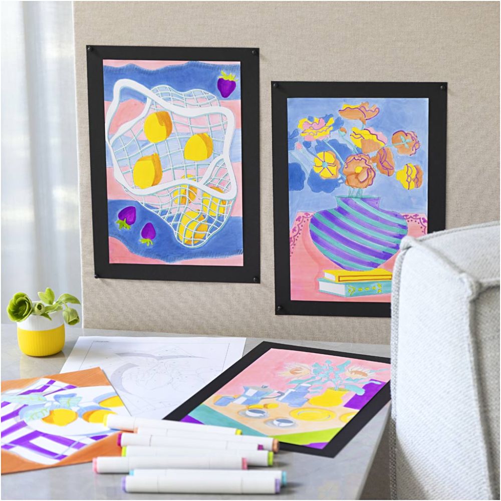 Colorful children's artwork on a wall with markers on a table below.