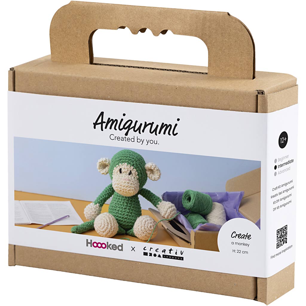 Box packaging for a green monkey amigurumi kit with 'Amigurumi Created by you' text.