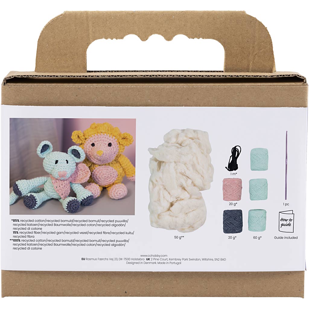 Cardboard box with yarn and crochet toys on a white background