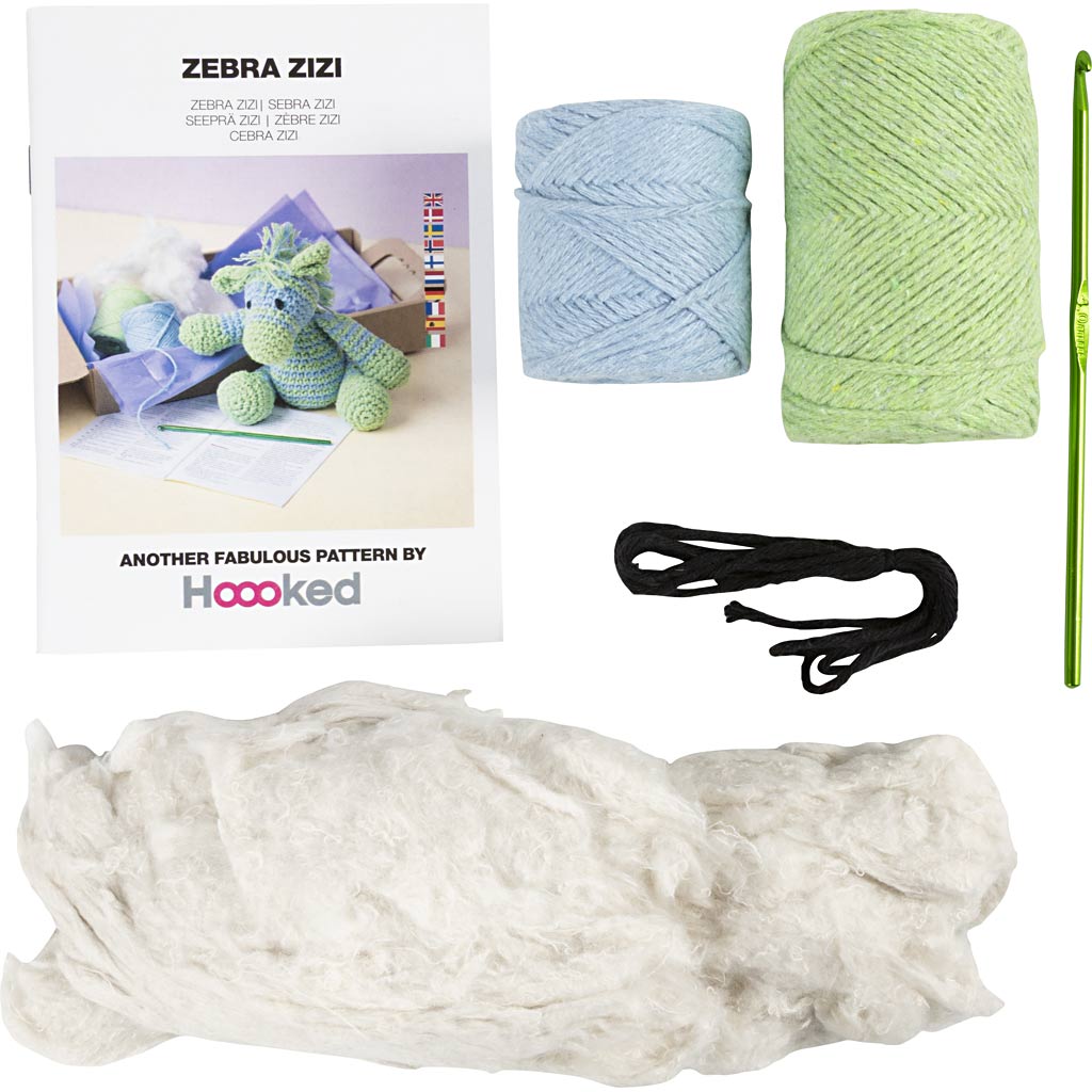 Knitting kit with yarn, needles, and pattern book displayed on a white background