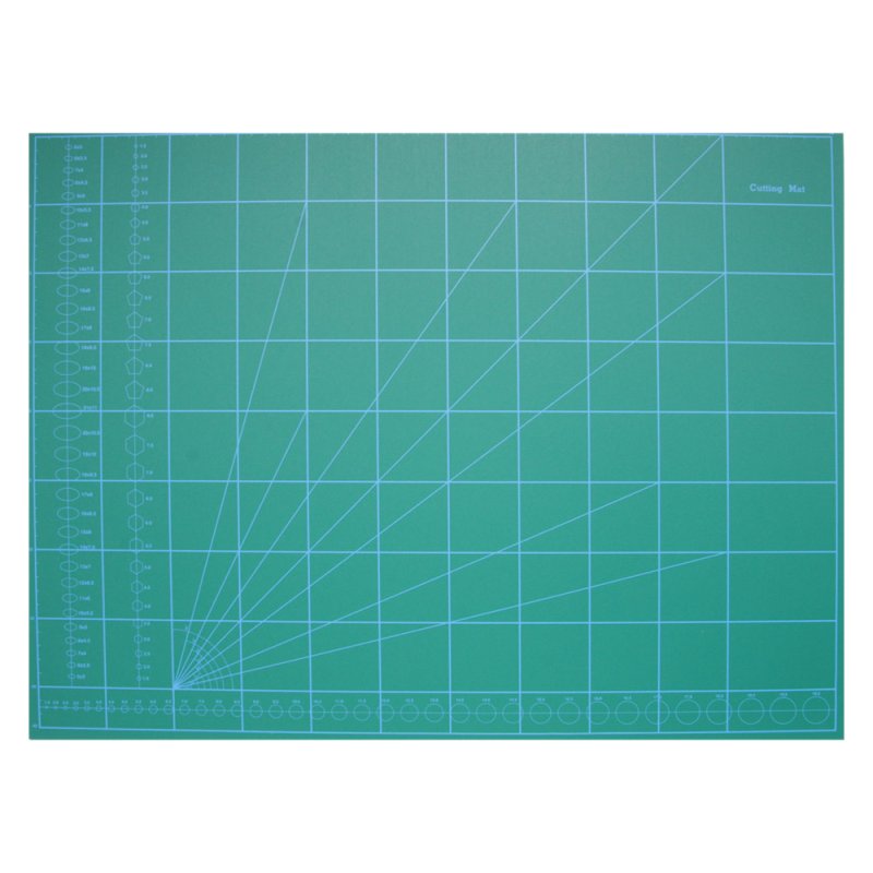 Green cutting mat with grid lines and measurements on a white background
