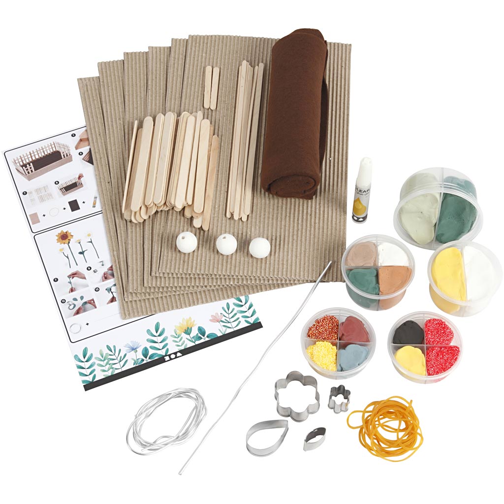 Craft kit with popsicle sticks, felt, and decorative items on a white background