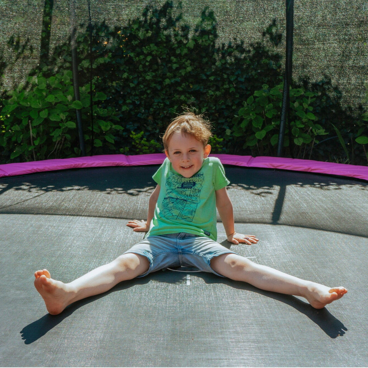 EXIT Silhouette Ground Round Trampoline with Safety Net - 12 Ft (Pink) in the garden