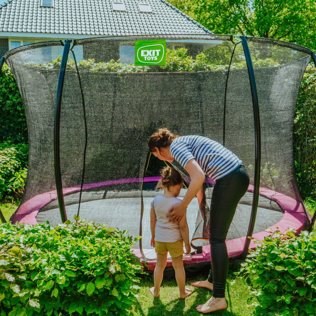 Exit Silhouette Ground Trampoline in Pink Outside Garden