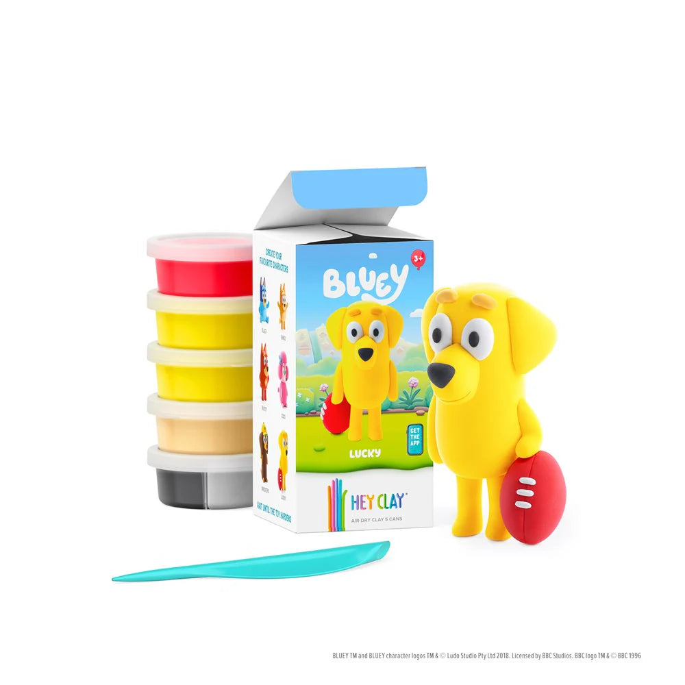 Blucy clay set with yellow dog figure, containers, and tool on a white background