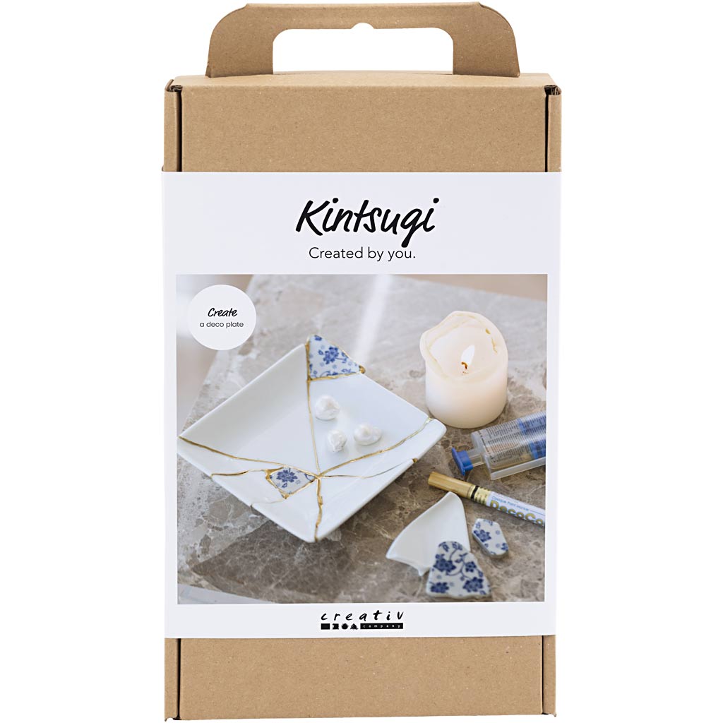 Kintsugi craft kit packaging with a candle and porcelain pieces on a white background
