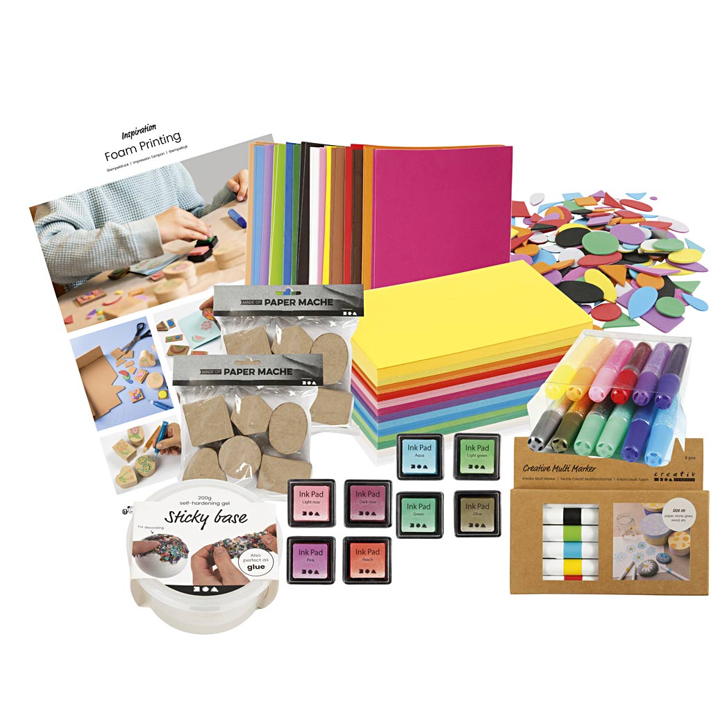 Assorted art supplies including paper, markers, and printing materials on a white background