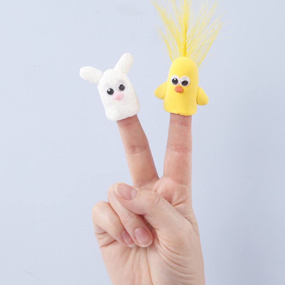 two fingers with a white finger puppet charachter and a yellow finger puppet character on a white background