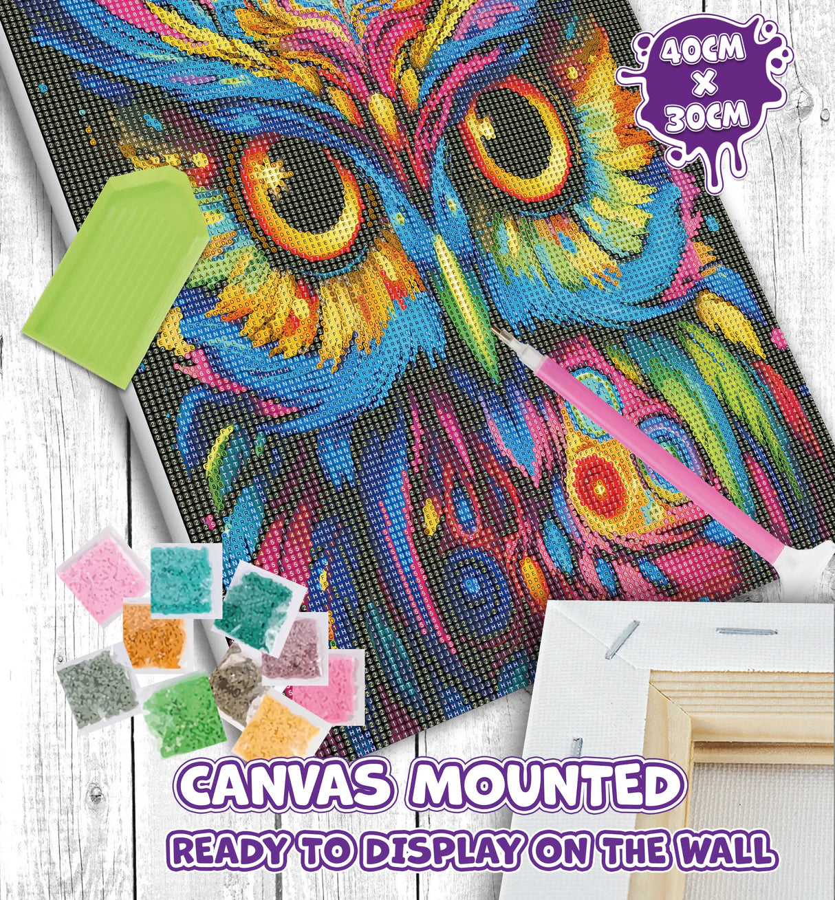 Colorful owl diamond painting kit with tools and canvas on a wooden surface