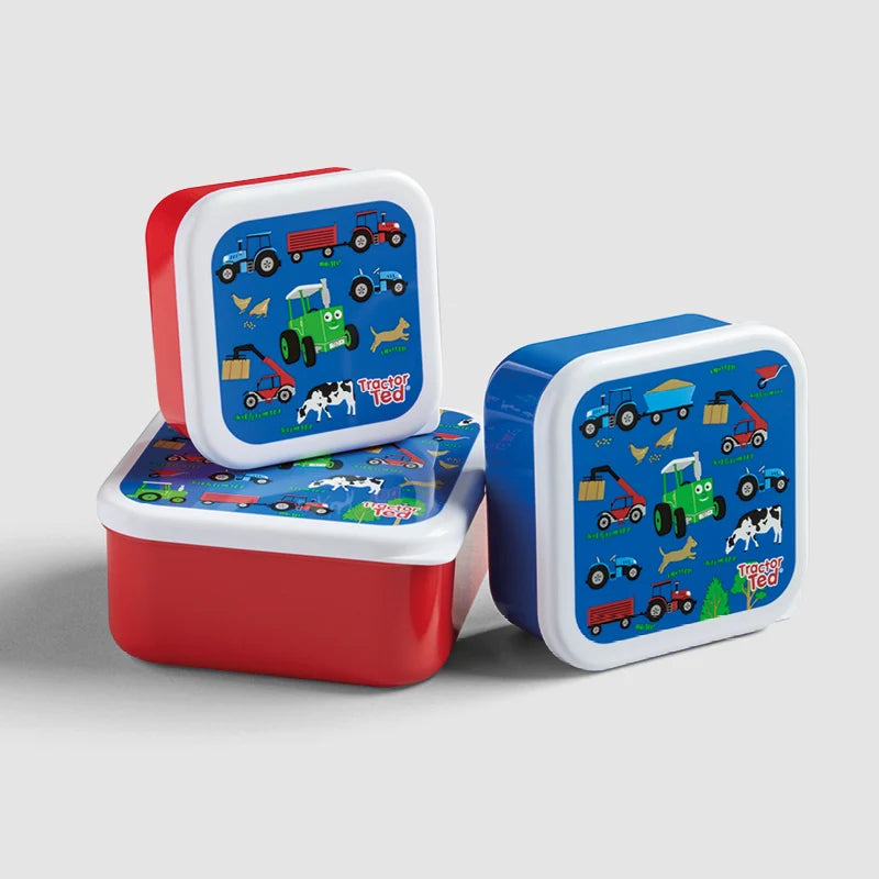 Set of three children's lunch boxes with farm and vehicle designs on a light gray background