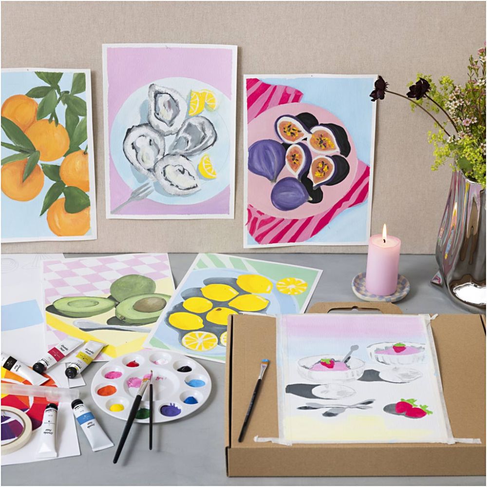 Artistic paintings of fruits and food on a table with art supplies.