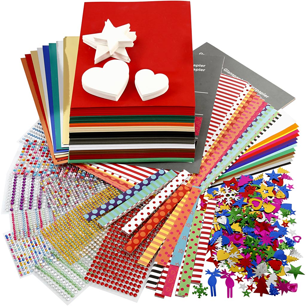 Assorted craft supplies including paper, stickers, and embellishments on a white background