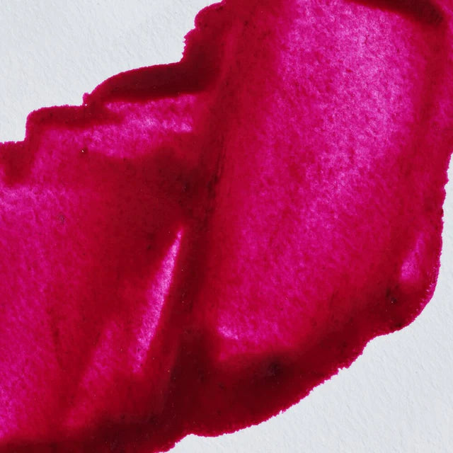 Close-up of a bright pink paint on a white background