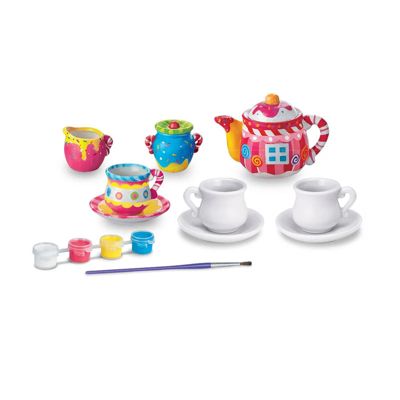 Colorful toy tea set with teapot, cups, and utensils on a white background