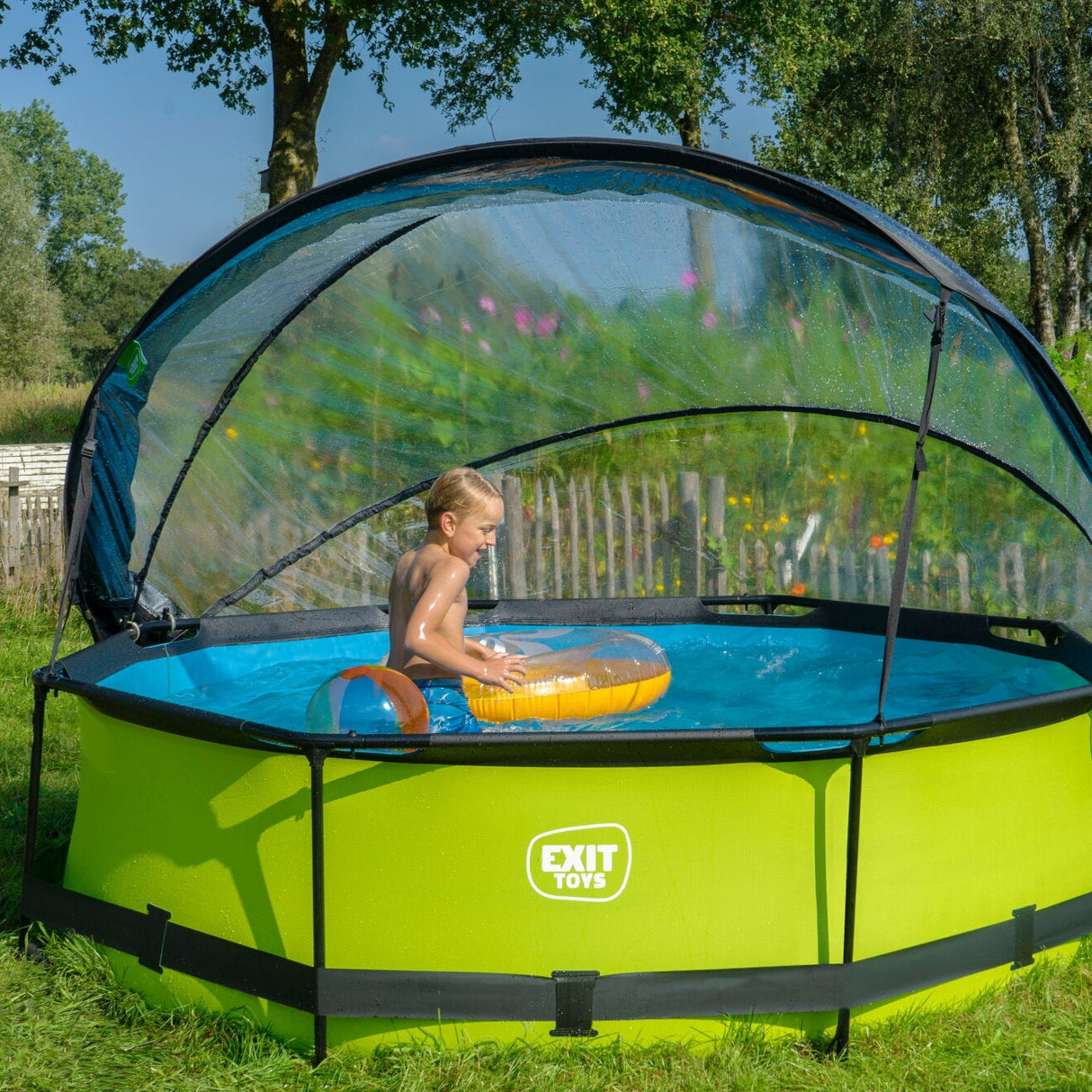 Green inflatable pool with canopy in a garden setting