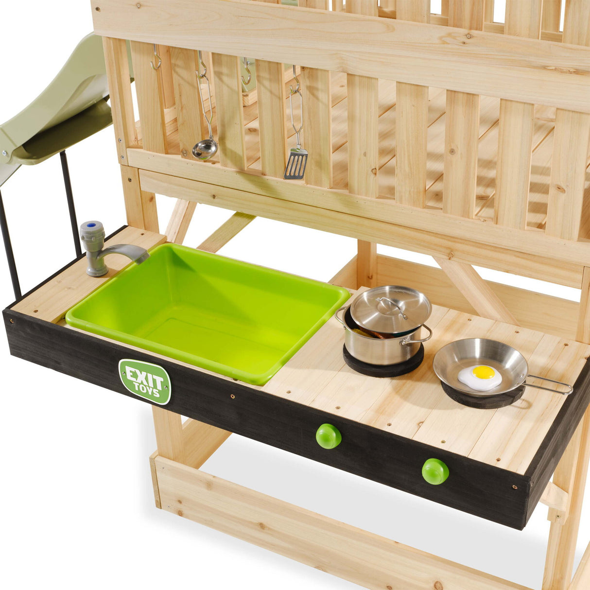 Wooden play kitchen set with a green tray and various accessories on a white background
