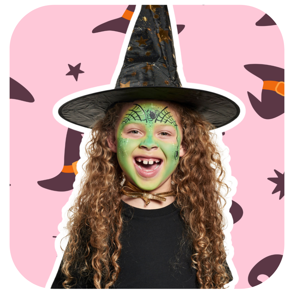 A child smiling and dressed as a witch with Snazaroo Green and black face paint