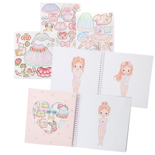 Set of paper dolls with accessories and a notebook featuring a girl character.