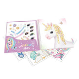 Unicorn-themed stationery set with notebook, stickers, and pen on a white background