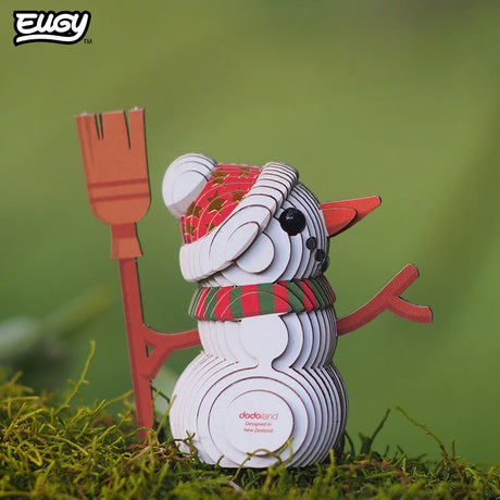 3D paper snowman model with a broom on a grassy background, featuring the Elgo brand.