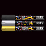 Three Liquitex paint markers in black, silver, and gold on a black background