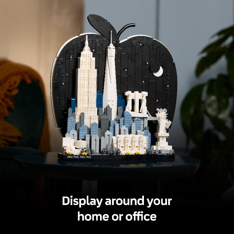 LEGO model of a cityscape in an apple-shaped display case with text 'Display around your home or office'.