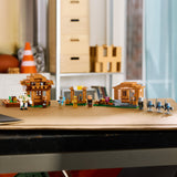 LEGO mini village set on a wooden table with blurred background