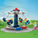LEGO amusement park ride set with colorful characters on a green field background