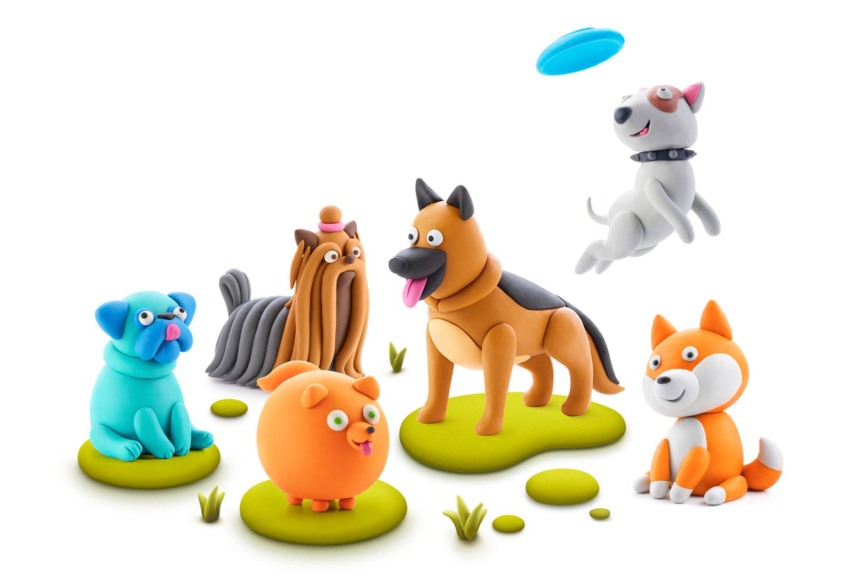 Colorful clay dog figurines on a white background