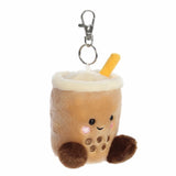 Plush keychain shaped like a bubble tea cup with a face on a white background