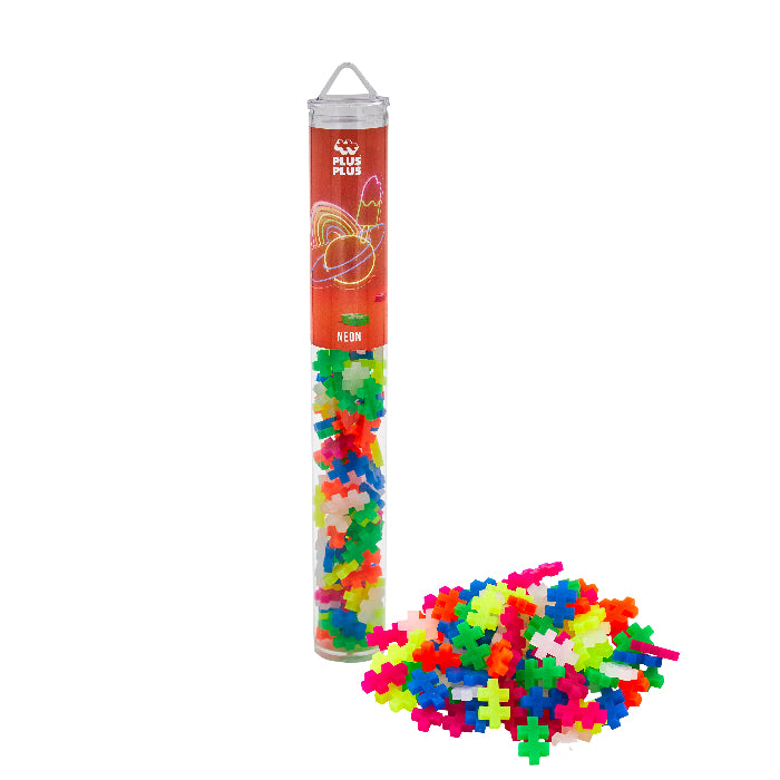 Colorful puzzle pieces in a cylindrical tube with Plus Plus branding on a white background.