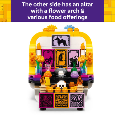 A colorful LEGO Day of the Dead altar building set shown against a white background with a purple text banner at the top describing features like an altar, flower arch, and food offerings.