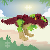 Toy dinosaur model with red, green, and beige colors on a pixelated background