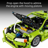 Green toy car with open hood showing engine with moving pistons, text 'Prop open the hood to admire the engine with moving pistons'.